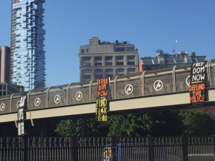 Black Lives Matter banners on the Holland Tunnel pedestrian bridge