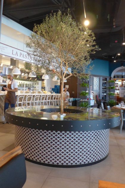 Pasta counter and olive tree at Eataly Downtown