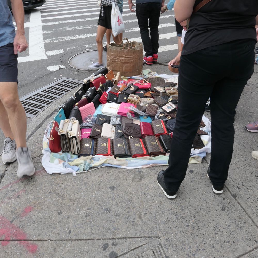 Vendors selling imitation designer bags on Canal Street in New